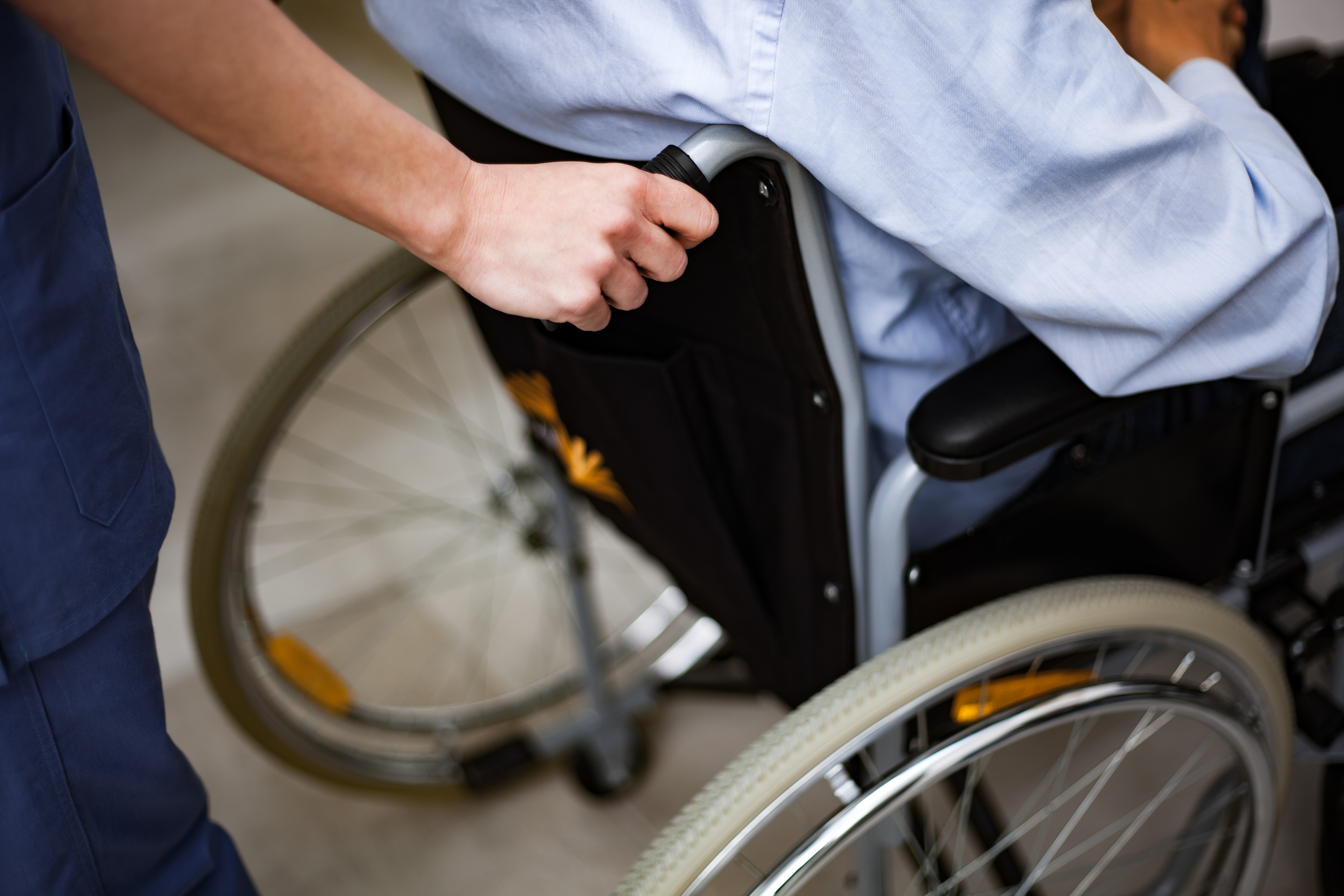 Nurse pushing an injured patient on a wheelchair